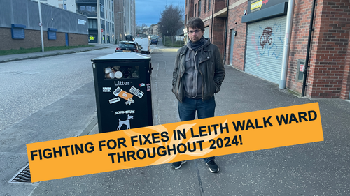 Cllr Jack Caldwell standing next to a full litterbin