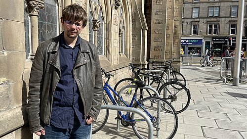 Jack Caldwell standing in front of bike racks