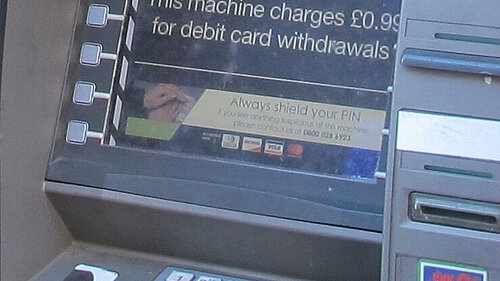 A cash machine screen showing a £0.99 fee for debit card withdrawls