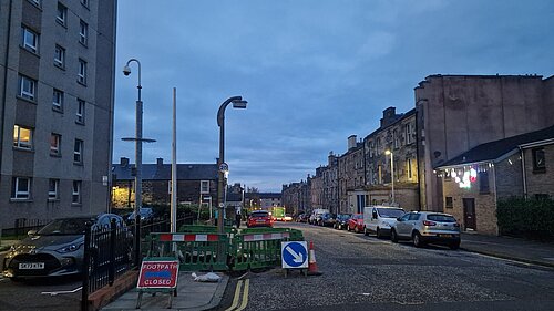 A lamppost at twighlight on Spey Terrace with roadworks around it.