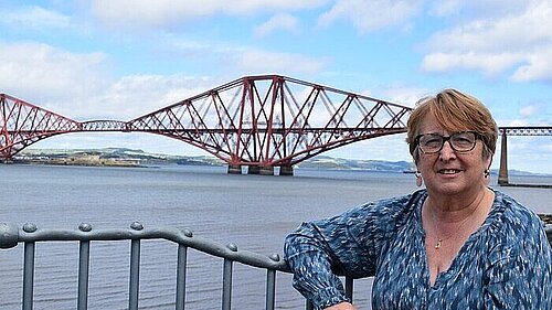 Christine Jardine standing in the foreground with the Forth Bridges in the background