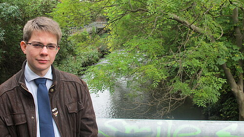 A man standing next to a river