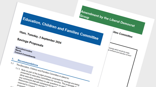 A report titled 'Savings Proposals' and a sheet of paper behind it titled 'Amendment by the Liberal Democrat Group'