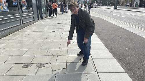 Jack Caldwell pointing at pavements