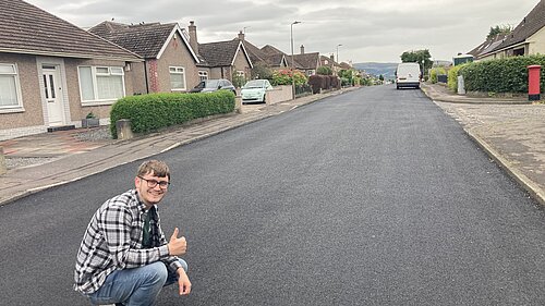 Councillor giving a resurfaced road a thumbs up